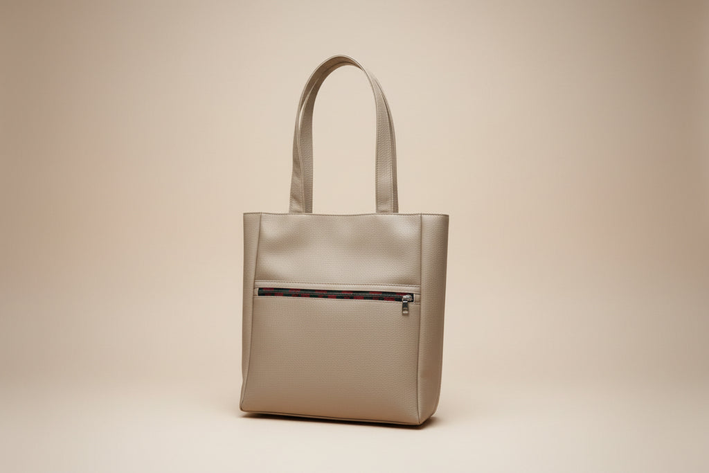 Beige handbag on a car seat with a visible brand logo.