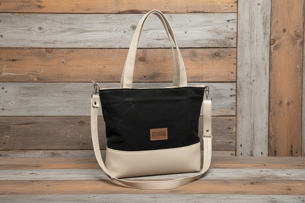 Black and beige tote bag on a wooden surface with a wooden wall background