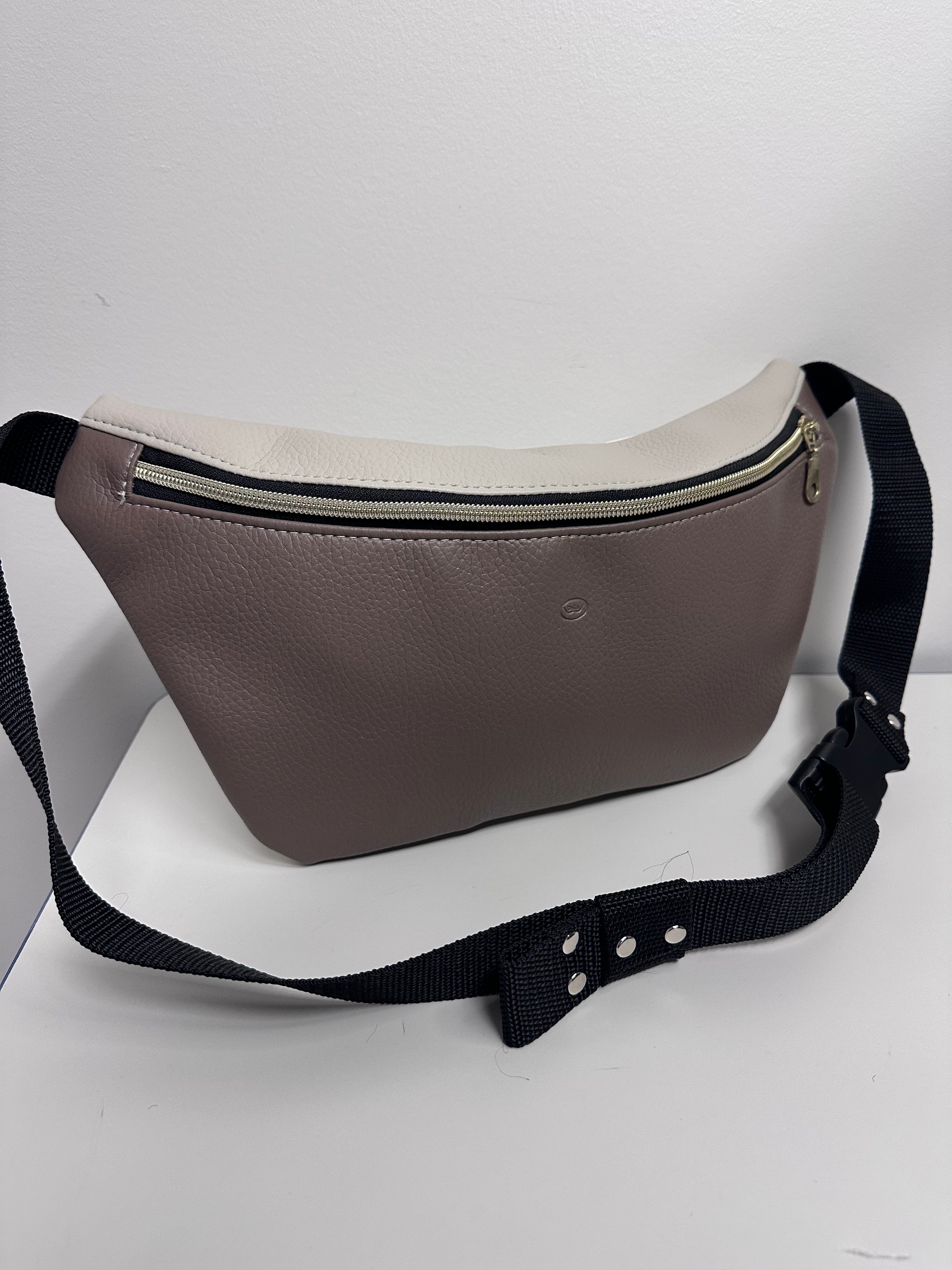 Brown waist bag with a black strap on a white background