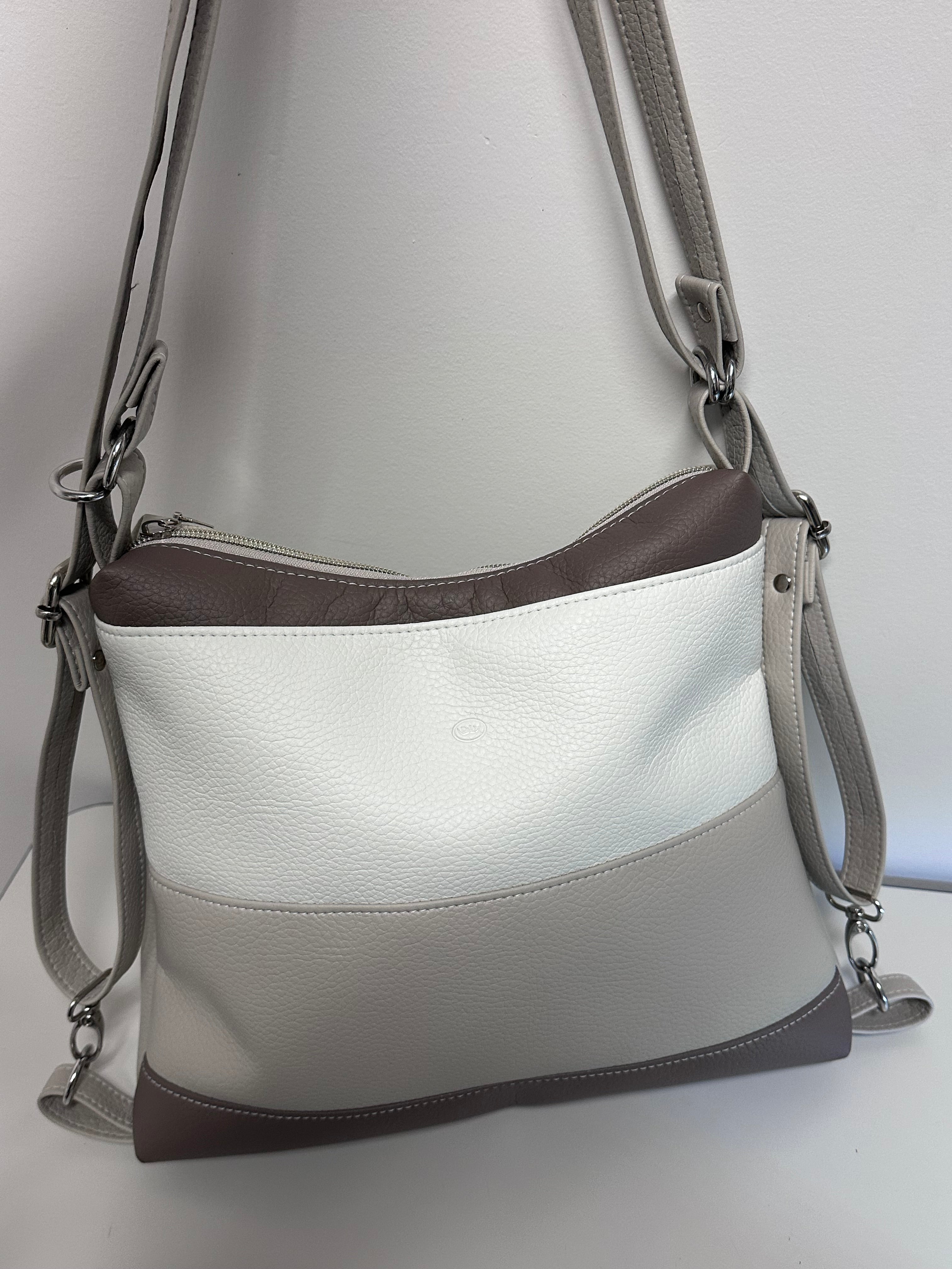 White handbag with brown accents on a light gray background