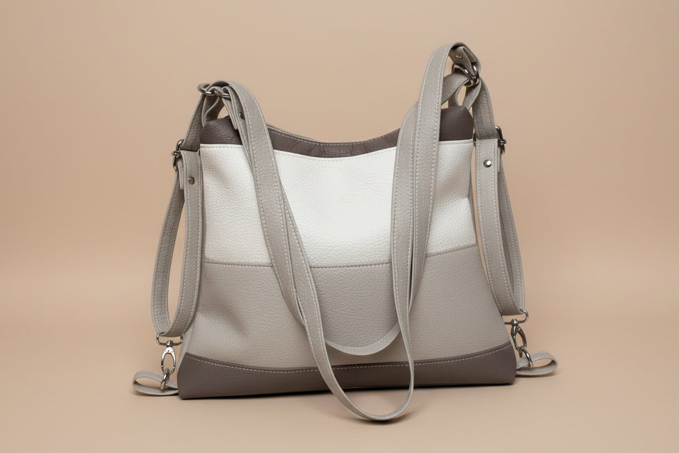 Gray handbag with a strap on a light gray background