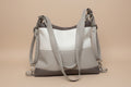 Gray handbag with a strap on a light gray background
