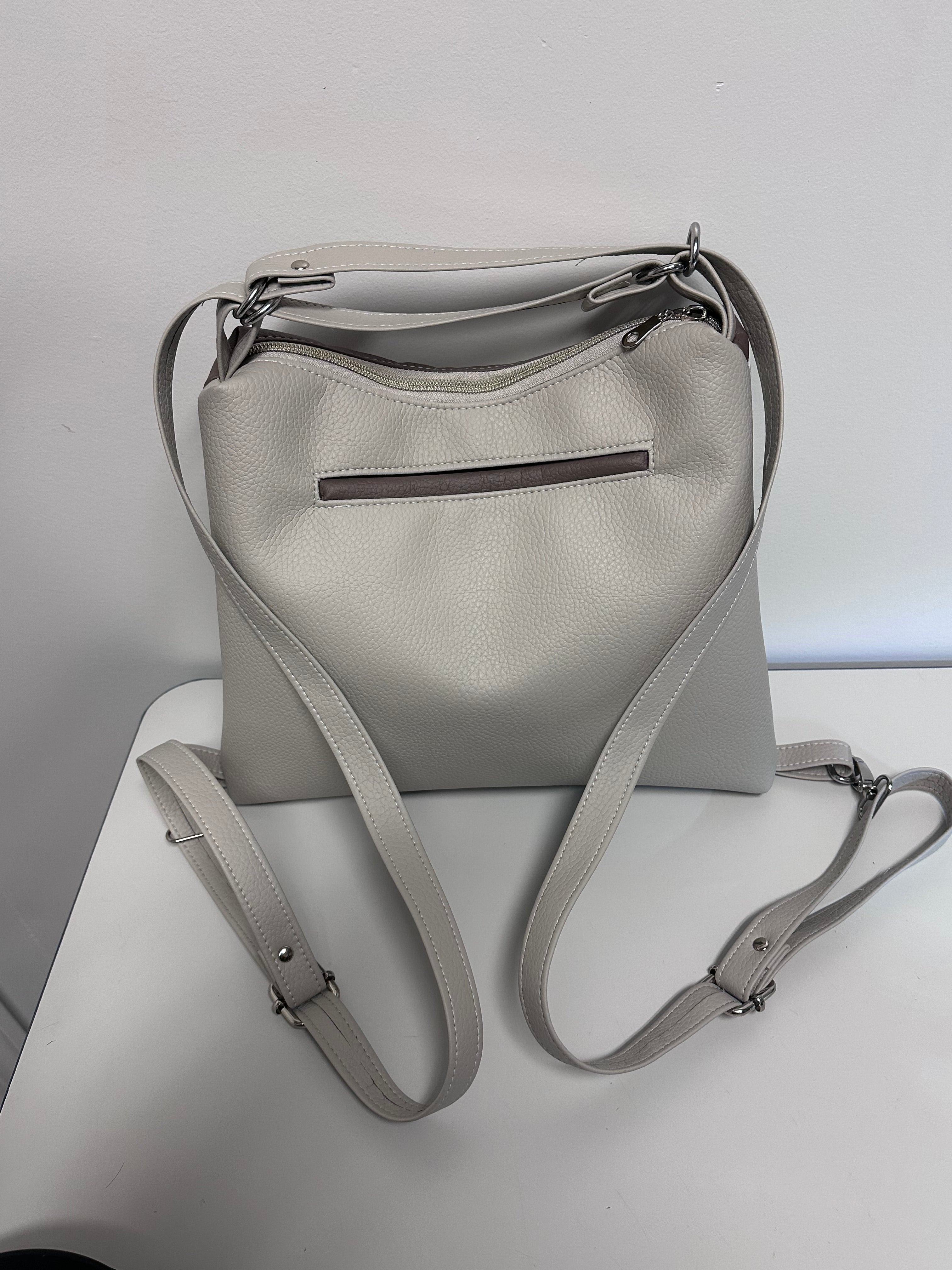 Gray faux leather backpack on a light gray background