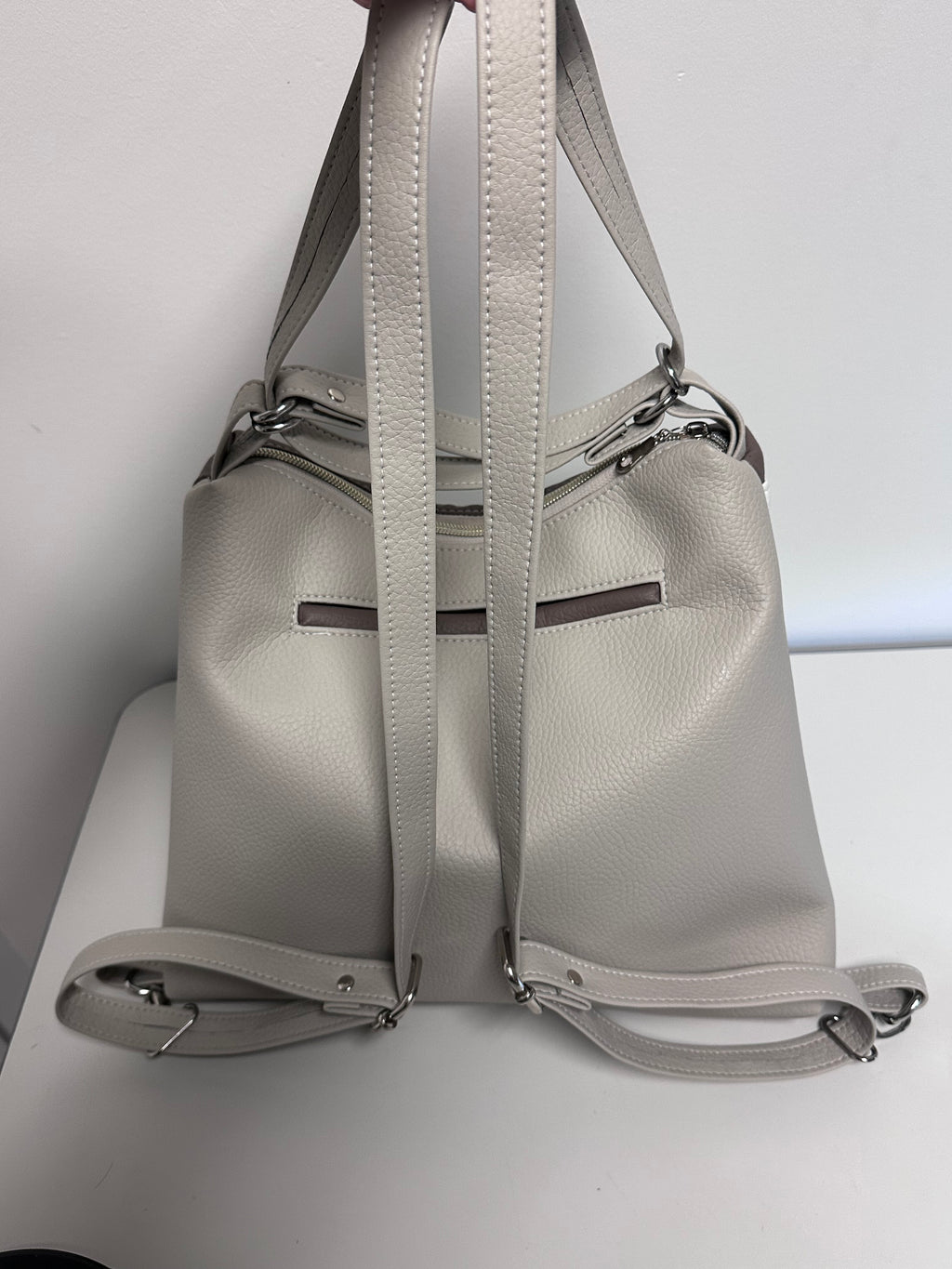 Gray handbag with a strap on a white background