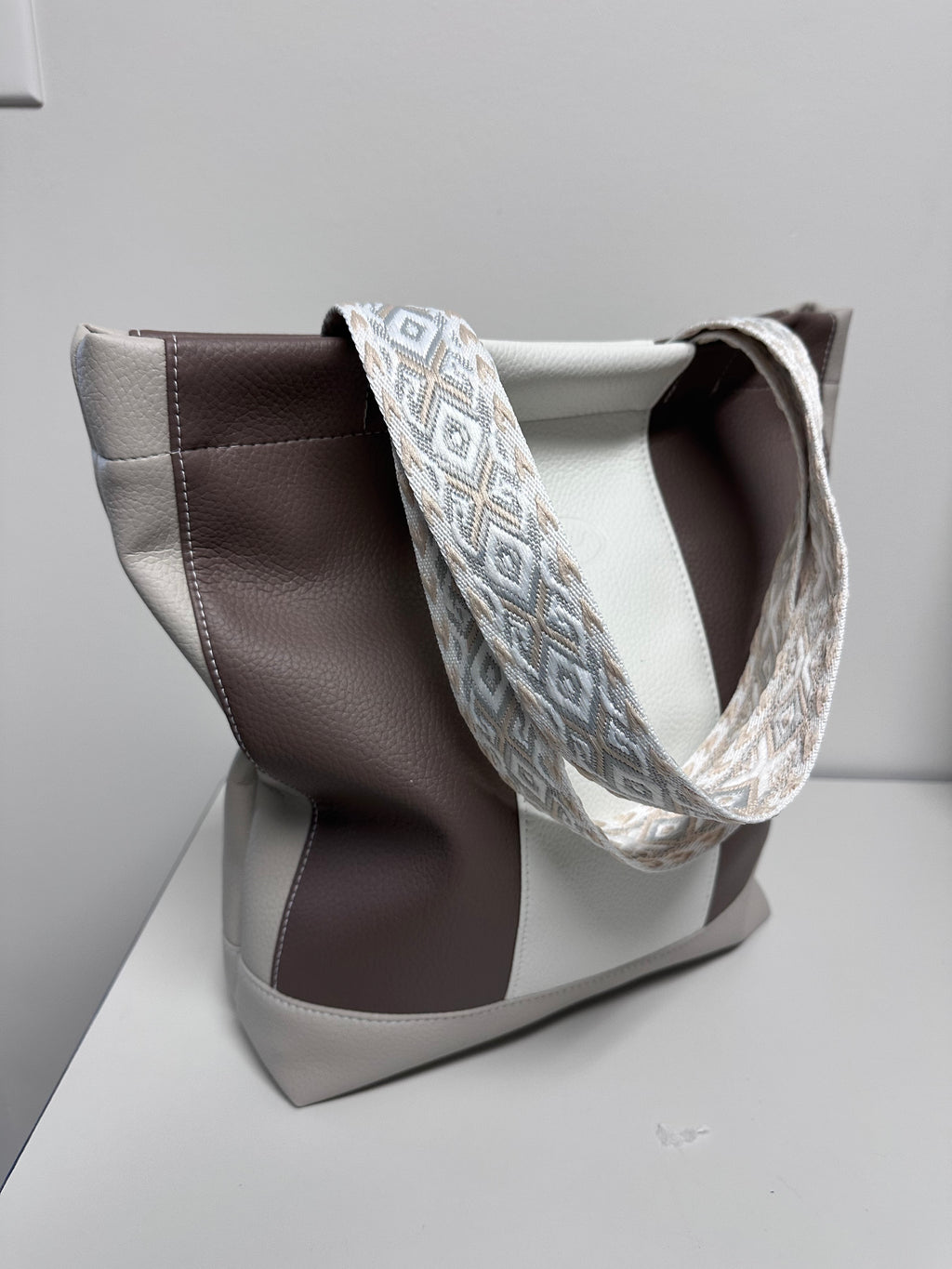 White and brown handmade bag with patterned strap