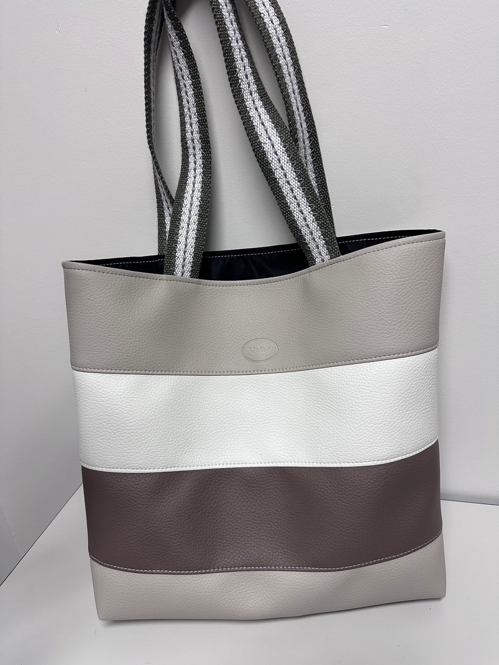 Gray tote bag with a strap on a light gray background