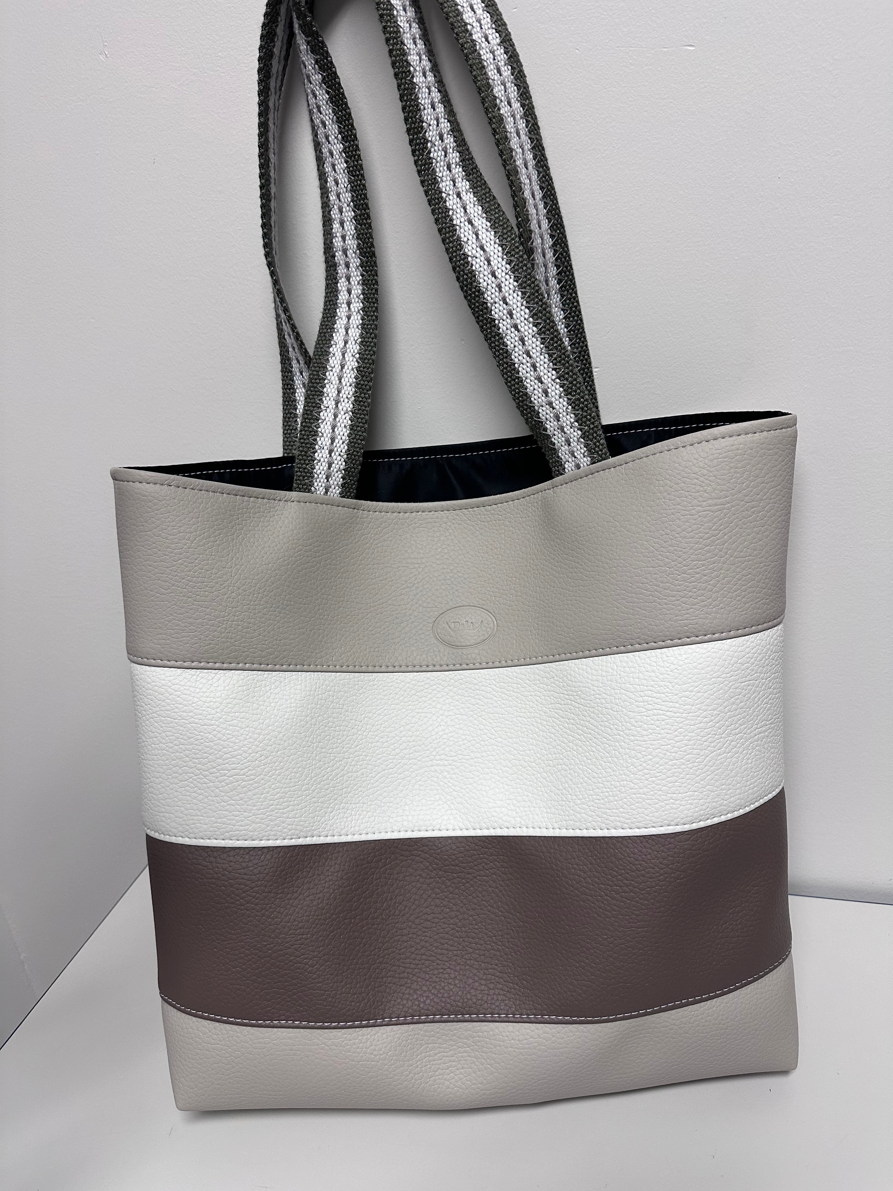 Gray tote bag with a strap on a light gray background