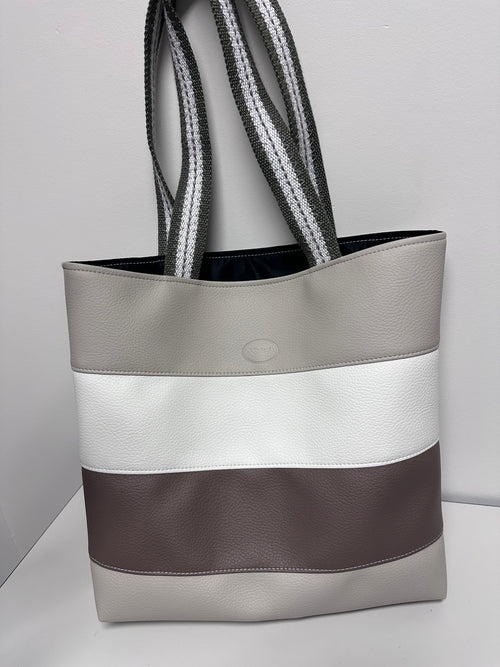 Gray tote bag with a strap on a light gray background