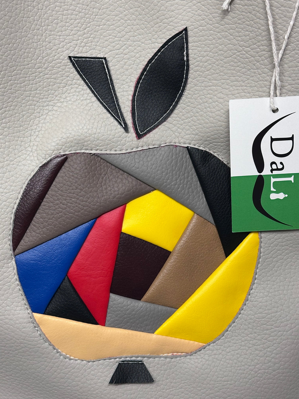 Colorful Apple Mosaic on a textured surface with a 'DaLi' brand tag.