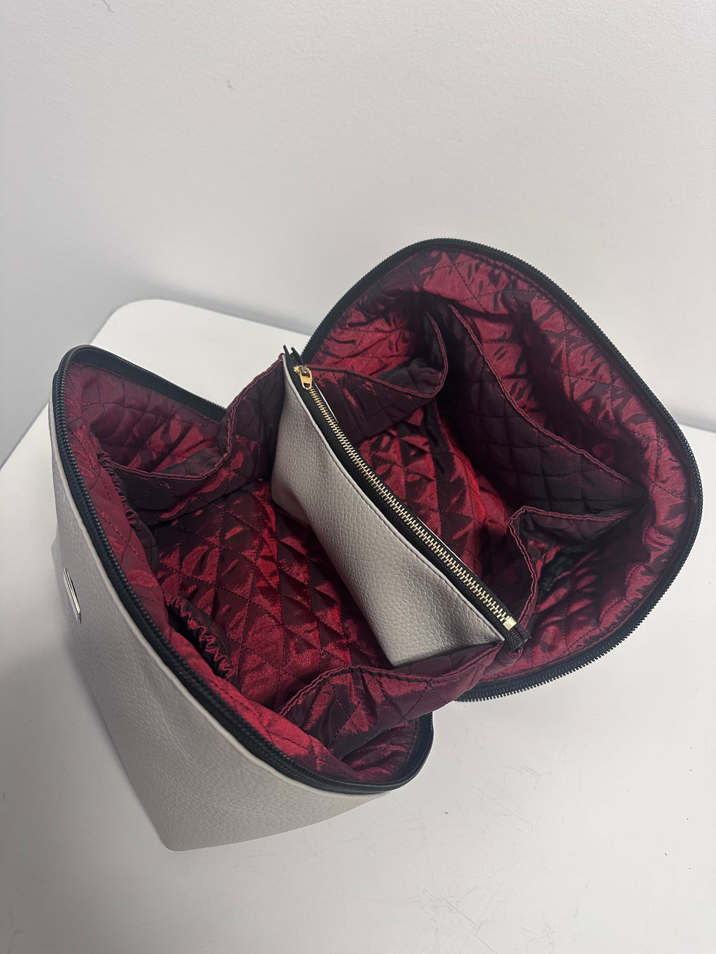 Gray bag with red interior lining on a white background