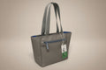 Gray tote bag with a blue interior held by a hand on a light gray background
