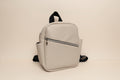 Light Grey backpack with a brand logo on a white background