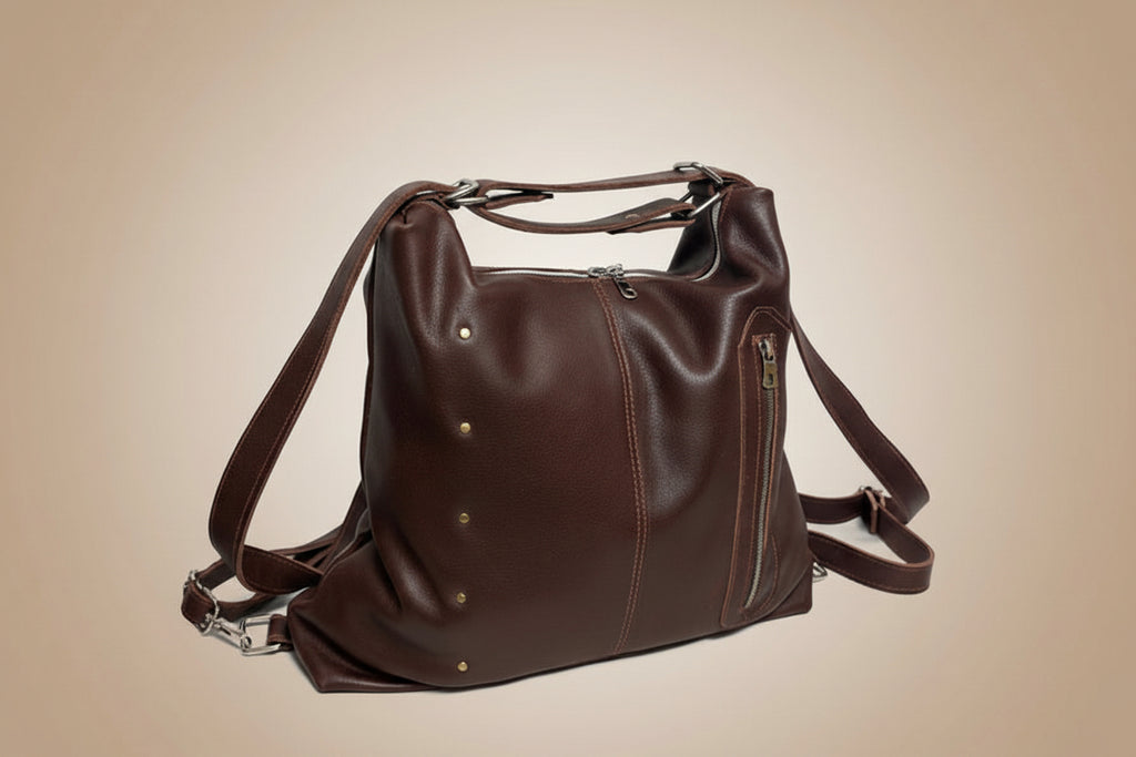 Brown leather bag with straps on a light gray background