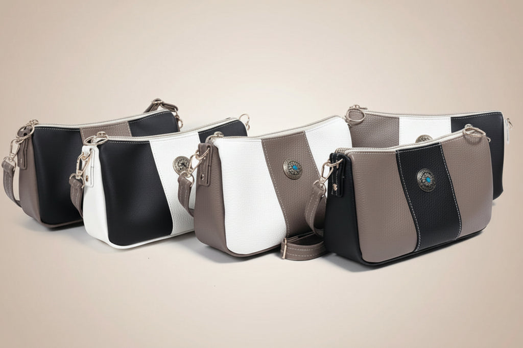 Stack of black, white, and gray handbags on a light gray background