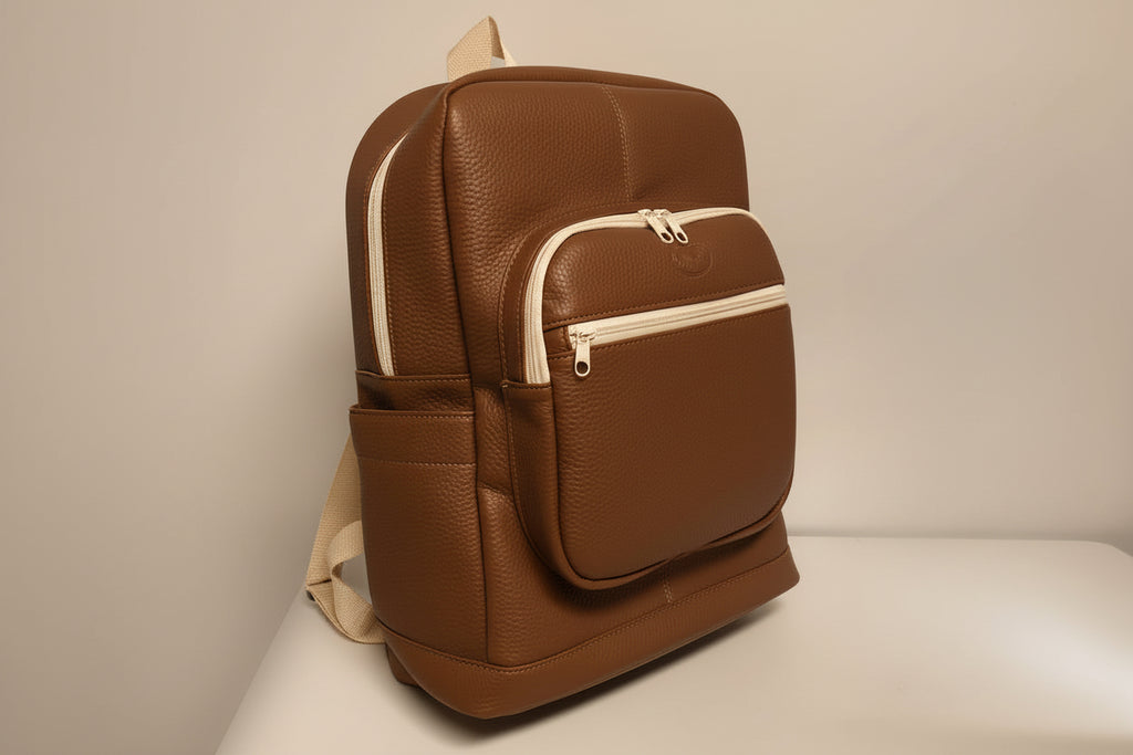 Brown faux leather backpack with beige accents on a light gray background