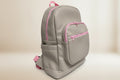 Gray backpack with pink zippers on a light gray background