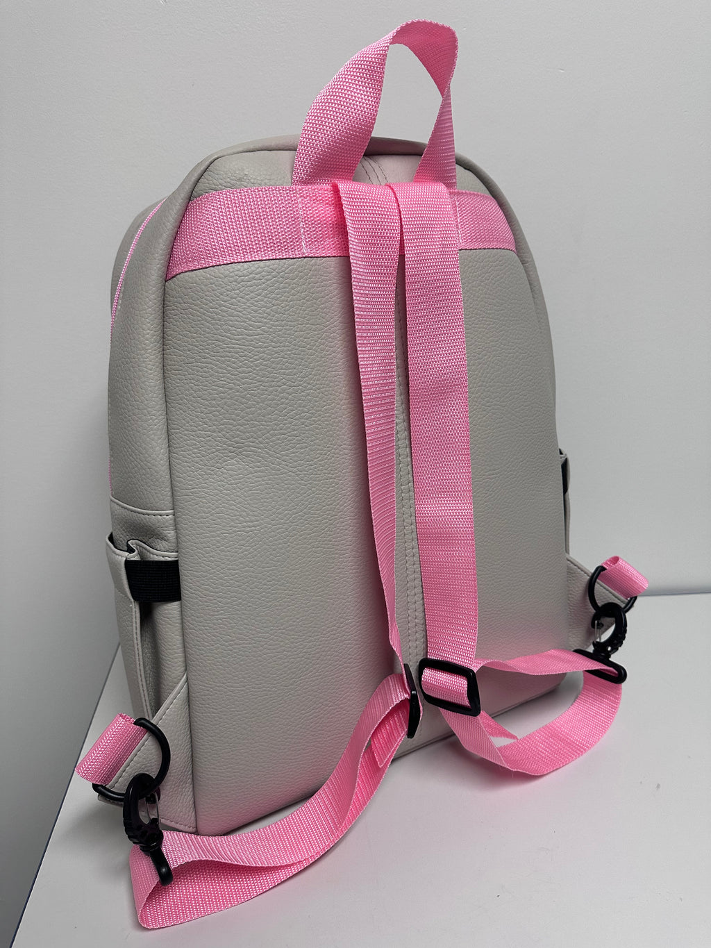 Gray bag with pink straps on a white background