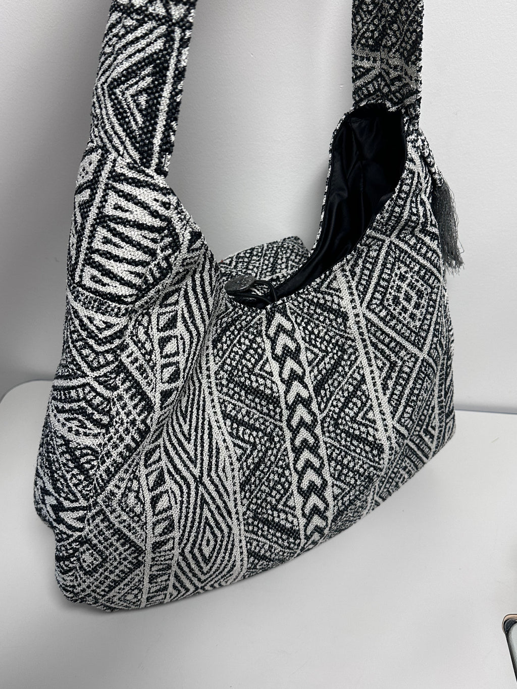 Black and white patterned bag against a white background