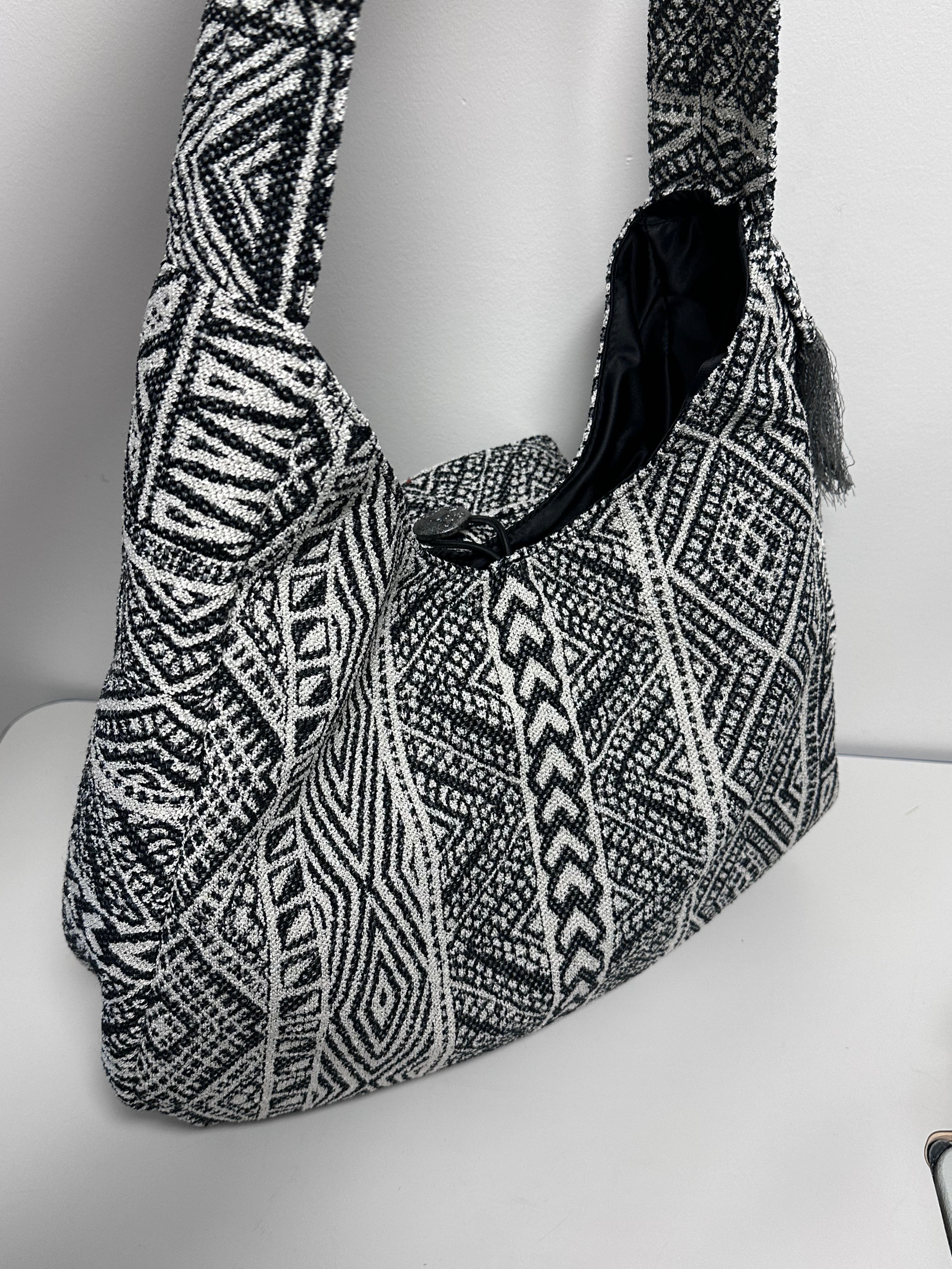 Black and white patterned bag against a white background
