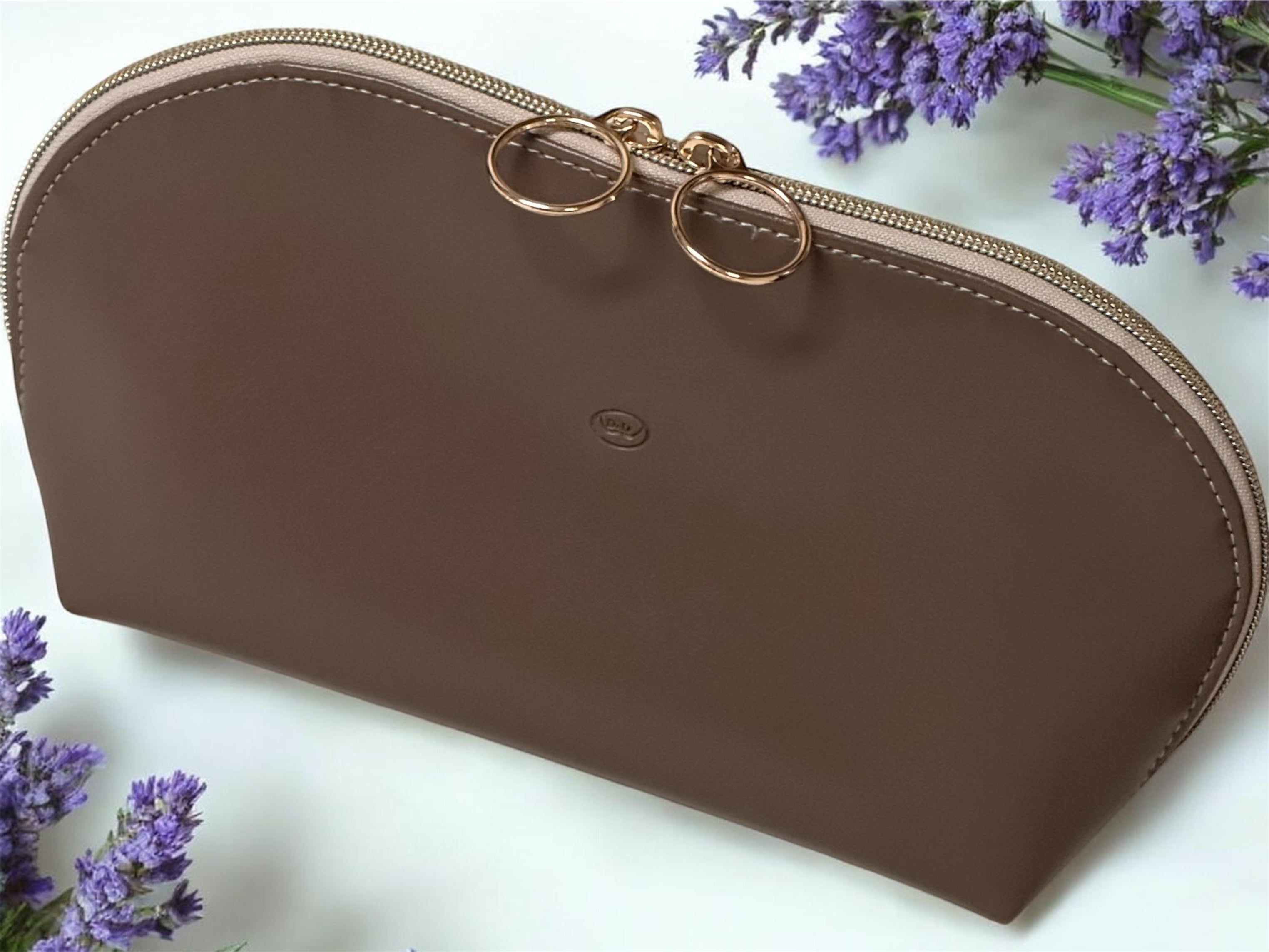 Brown pouch with gold zipper on a white background with lavender flowers